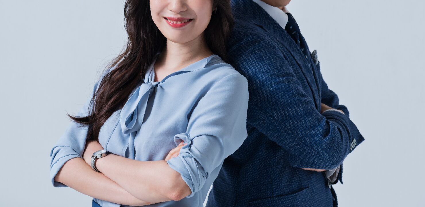 腕を胸の前で組んでいる男女